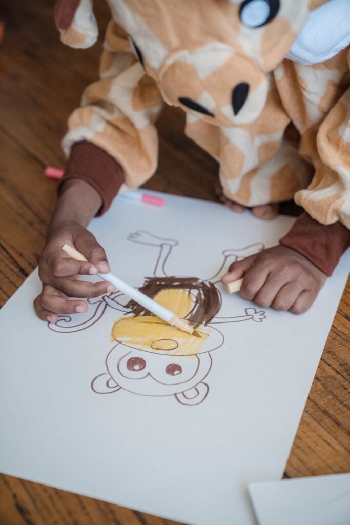 photo of a child holding colored marker