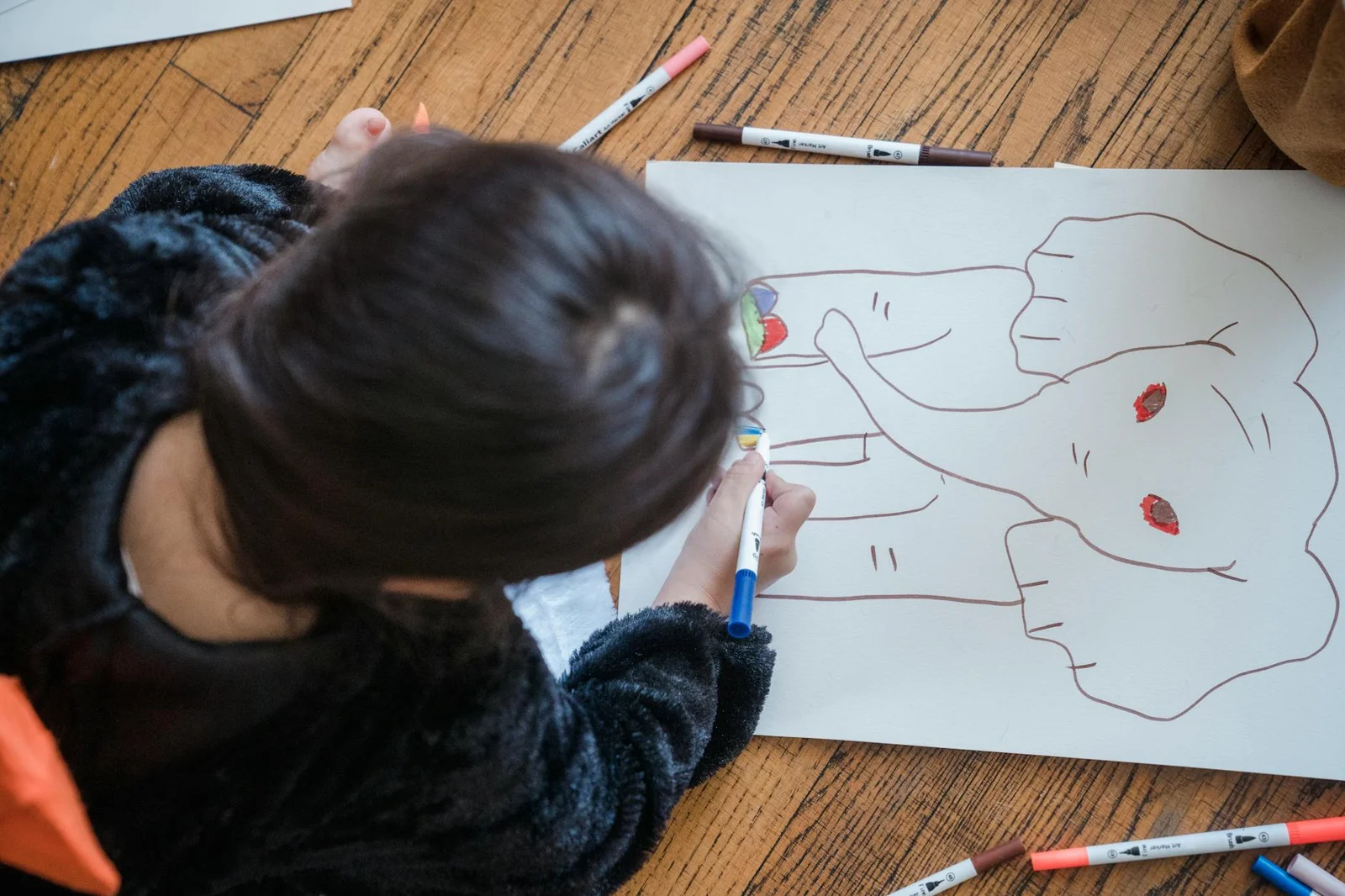 child coloring an elephant on paper